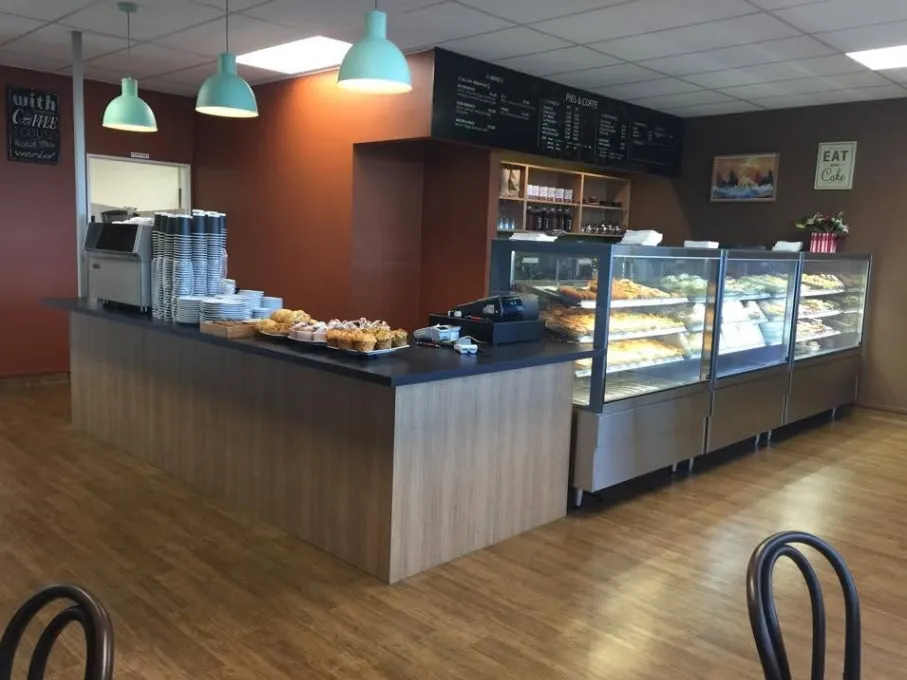 Inside the cafe: the counter and cabinets under mint pendant lights