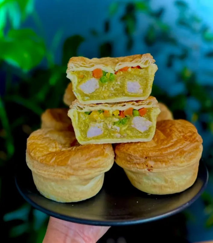 Chicken and vegetable pies, one cut open