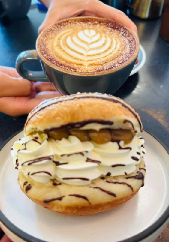 Cappuccino with a cream-filled bun