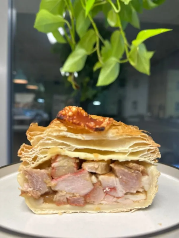 Slice of pork belly pie with crackling on top