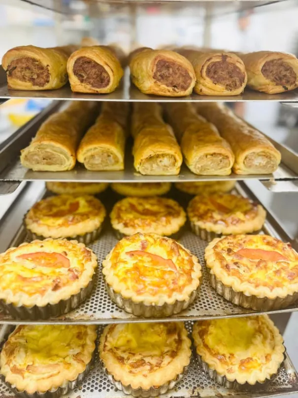 Racks of sausage rolls and quiches
